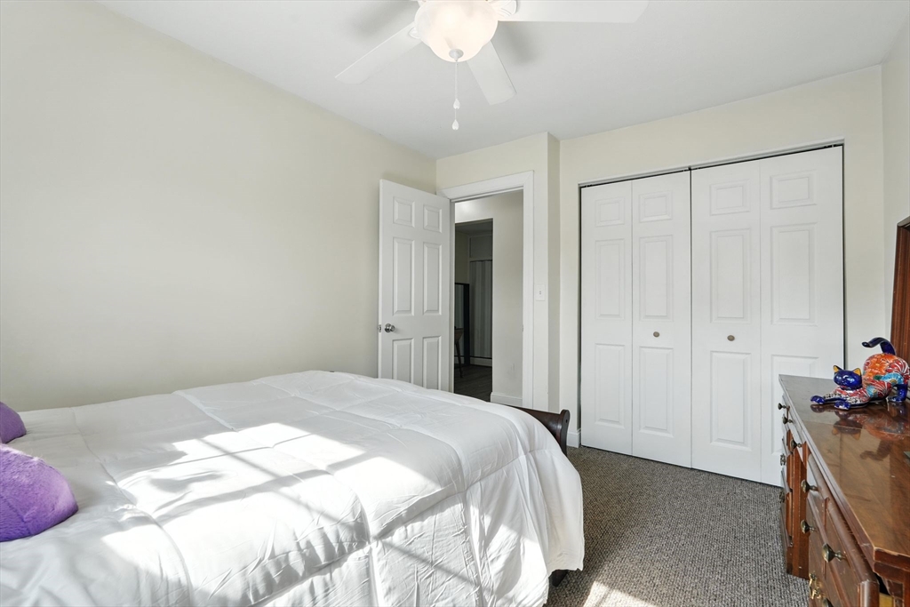 66 Applewood Drive, Unit 66 Chicopee, MA 01022 - Photo 16 of 25 a bedroom with a bed and a chandelier