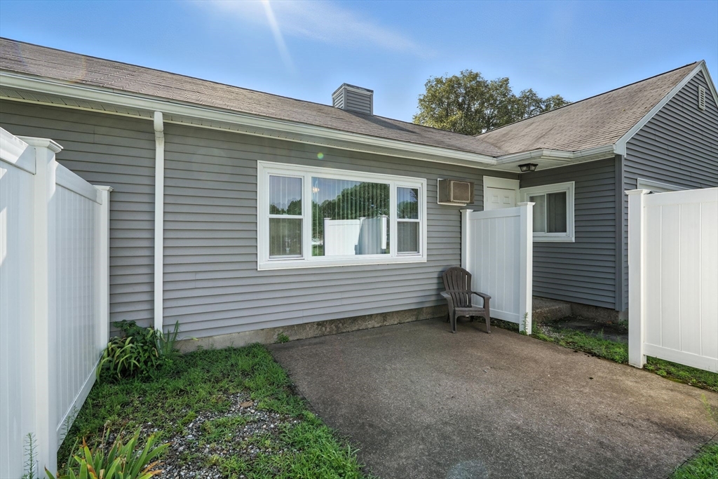 66 Applewood Drive, Unit 66 Chicopee, MA 01022 - Photo 21 of 25 a view of a house with a yard and wooden fence