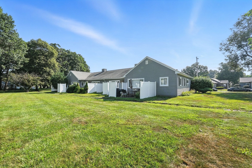 66 Applewood Drive, Unit 66 Chicopee, MA 01022 - Photo 23 of 25 a front view of house with yard and trees in the background