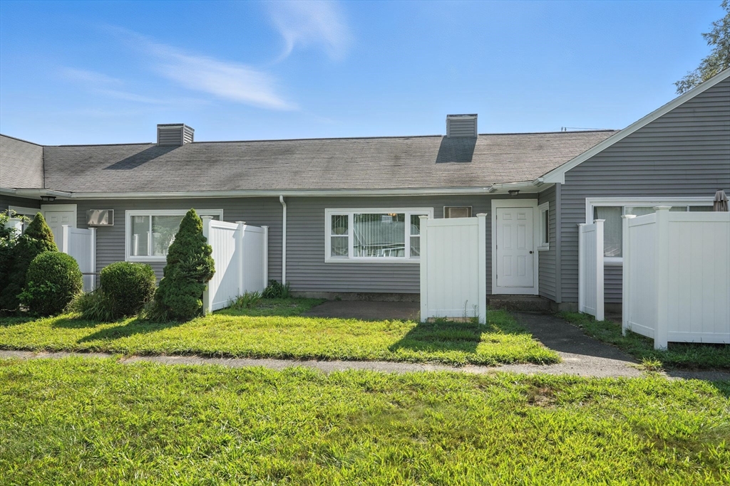66 Applewood Drive, Unit 66 Chicopee, MA 01022 - Photo 24 of 25 a front view of house with yard and garage