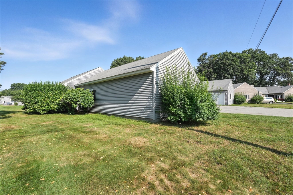 66 Applewood Drive, Unit 66 Chicopee, MA 01022 - Photo 25 of 25 a backyard of a house with plants and large tree