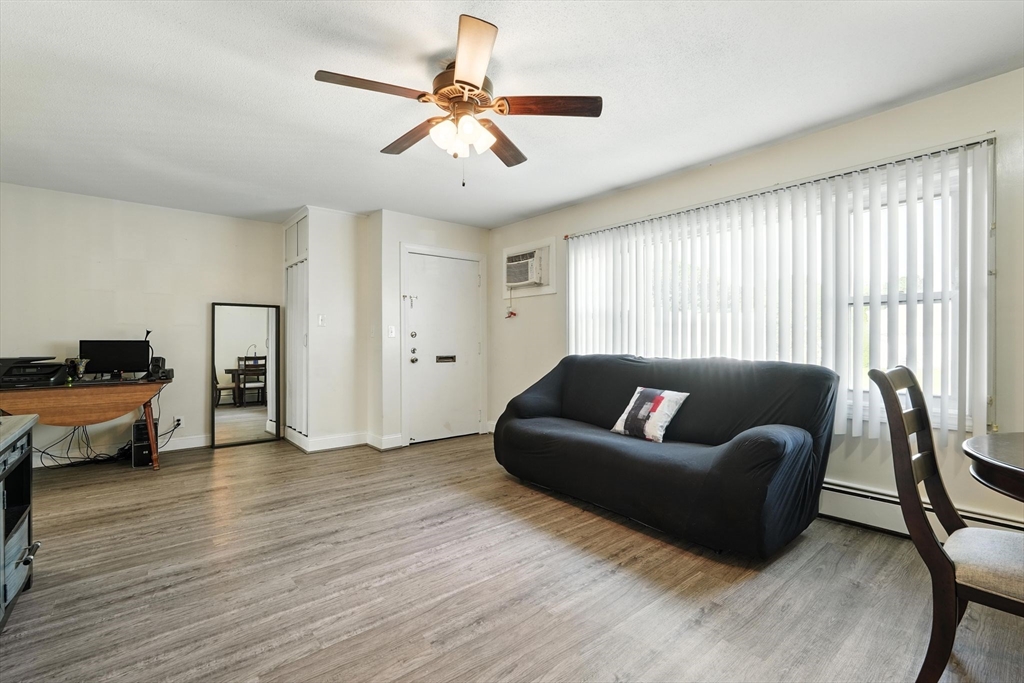 66 Applewood Drive, Unit 66 Chicopee, MA 01022 - Photo 6 of 25 a living room with furniture and a wooden floor
