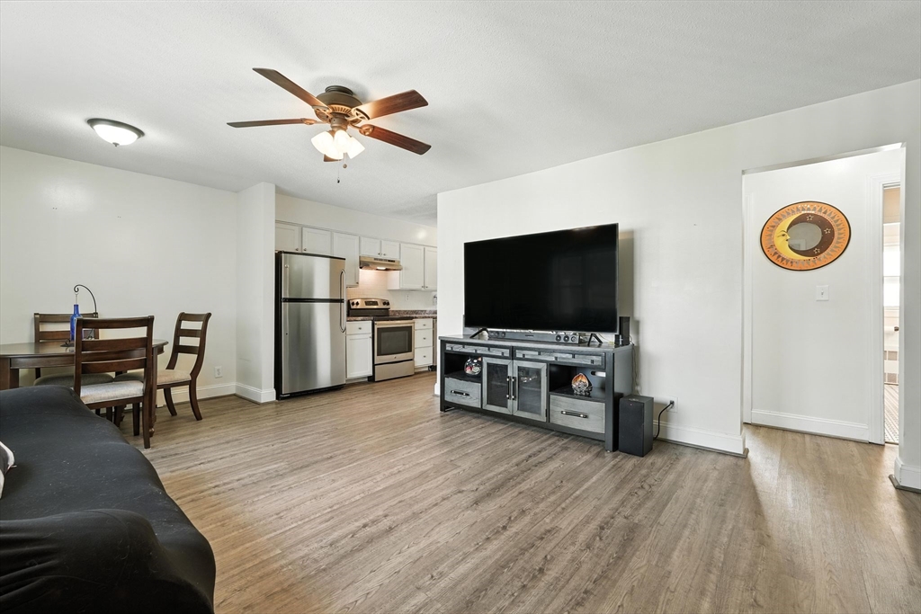 66 Applewood Drive, Unit 66 Chicopee, MA 01022 - Photo 8 of 25 a living room with furniture and a flat screen tv