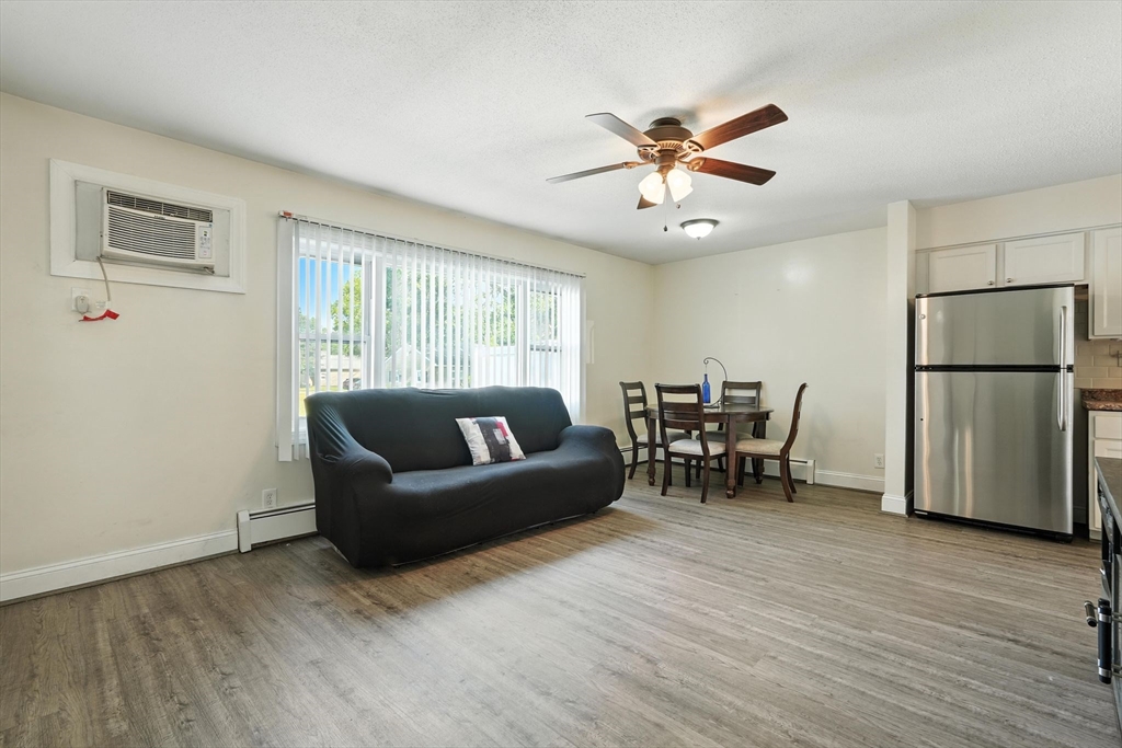 66 Applewood Drive, Unit 66 Chicopee, MA 01022 - Photo 9 of 25 a living room with furniture and a view of kitchen