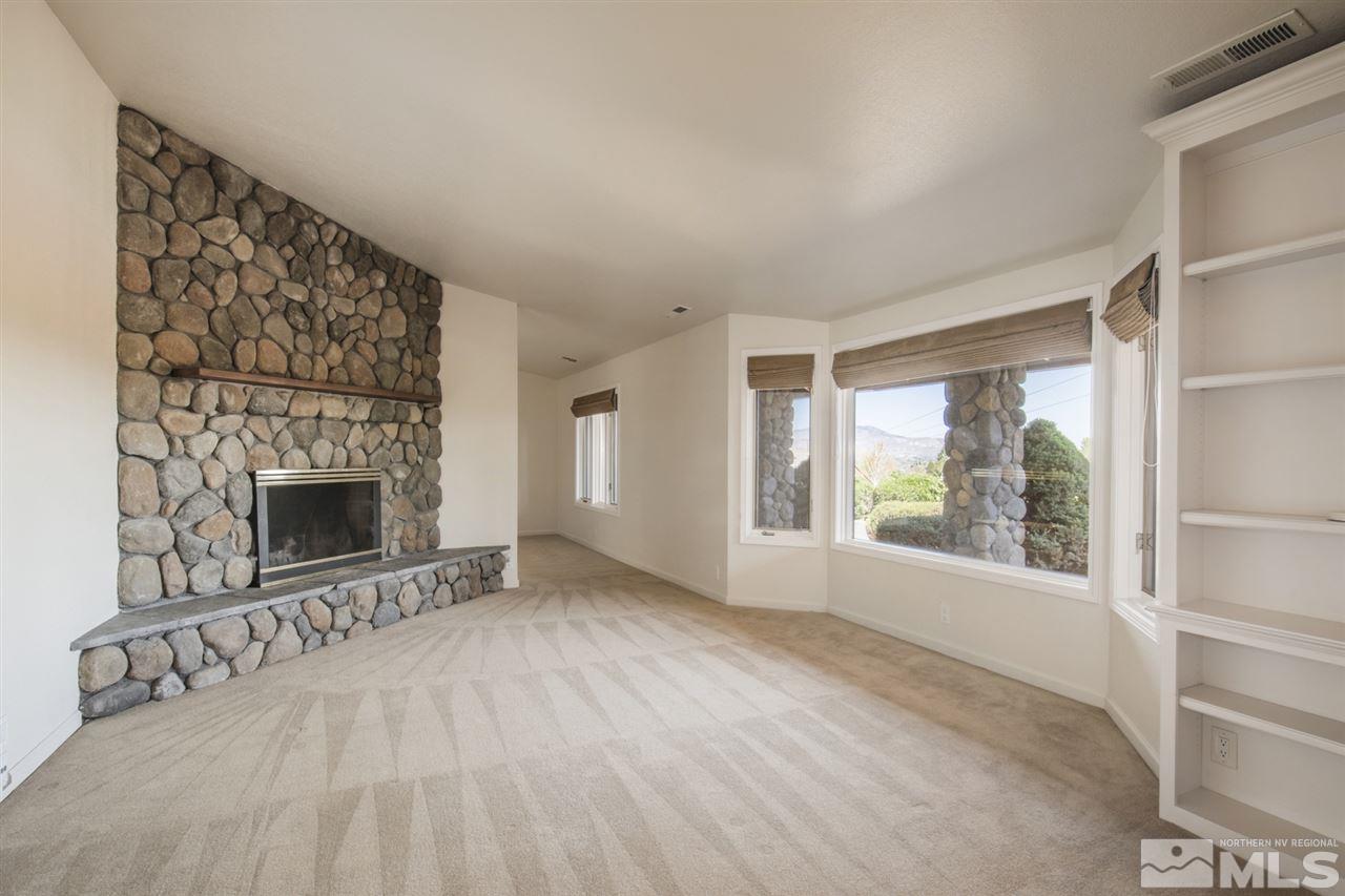12560 Thomas Creek Road Reno, NV 89511 - Photo 5 of 20 a view of an empty room with a fireplace and a window