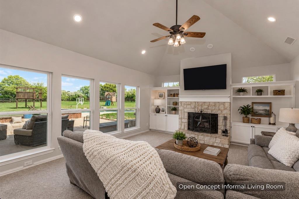 15 Trail Ridge Drive Melissa, TX 75454 - Photo 12 of 38 a living room with furniture a fireplace and a flat screen tv