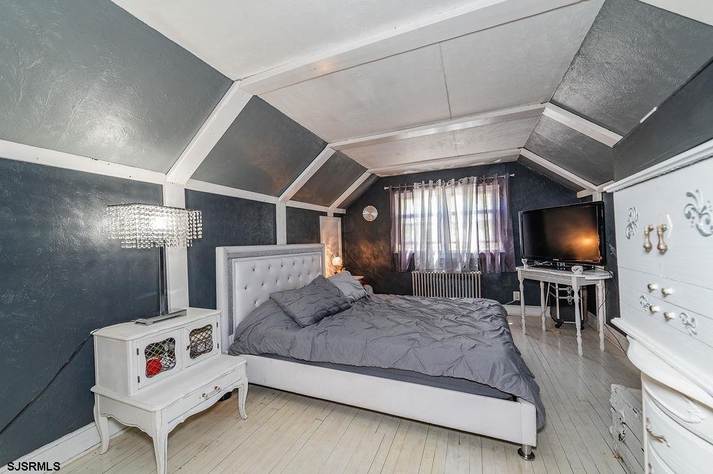 19 South 1st Road Hammonton, NJ 08037 - Photo 19 of 36 a spacious bedroom with a bed a flat screen tv and a couch