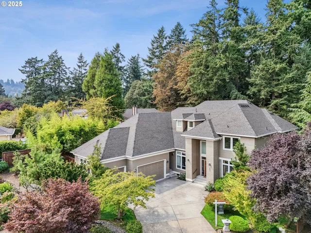 an aerial view of a house with a yard table and chairs