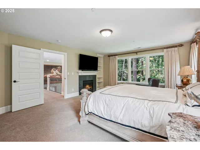 a spacious bedroom with a bed and a flat screen tv