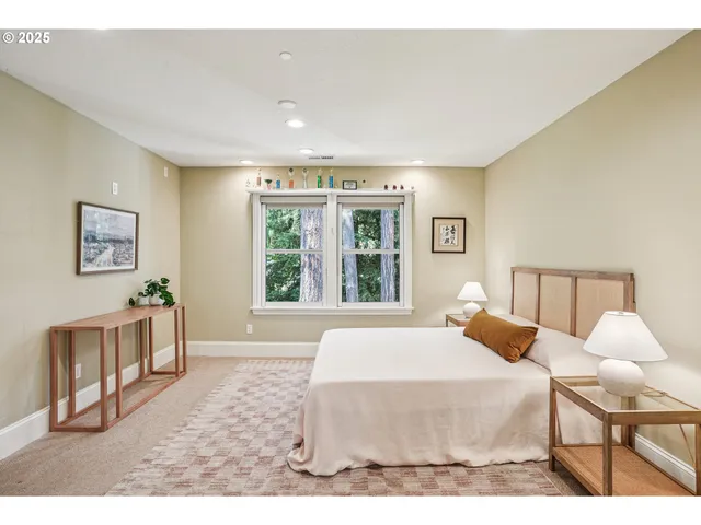 a bedroom with a bed and a large window