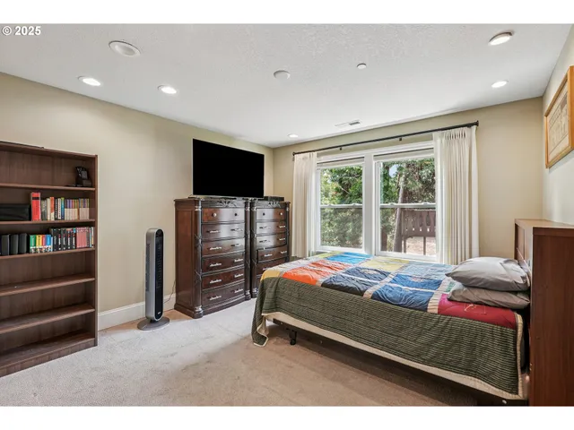 a bedroom with bed and tv