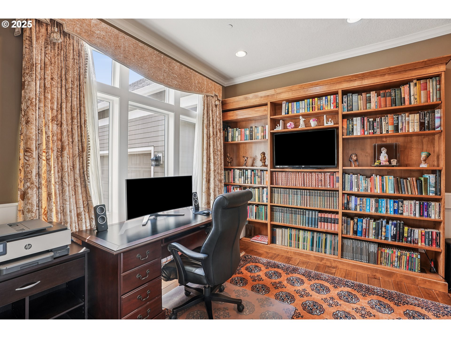1621 Southeast McBrod Avenue Milwaukie, OR 97222 - Photo 31 of 41 a view of a workspace with furniture and a book shelf