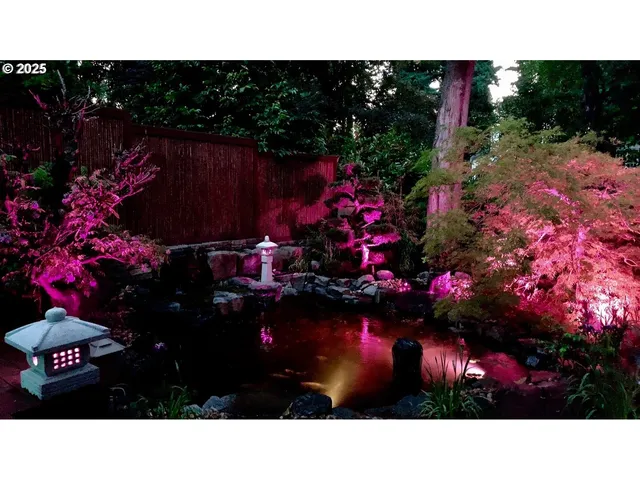 a view of backyard with potted plants and wooden fence