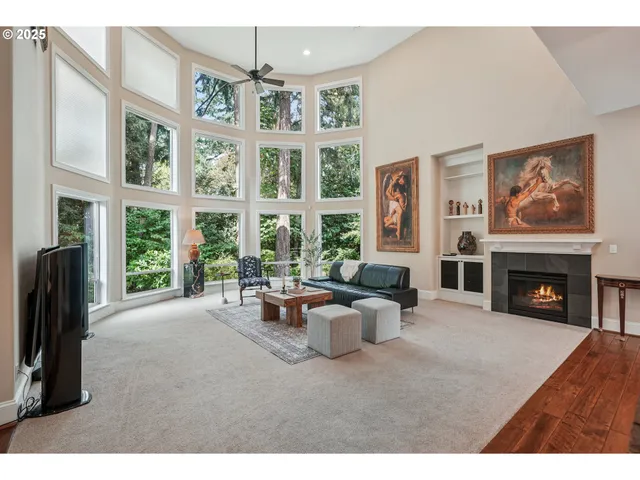 a living room with furniture large window and fireplace
