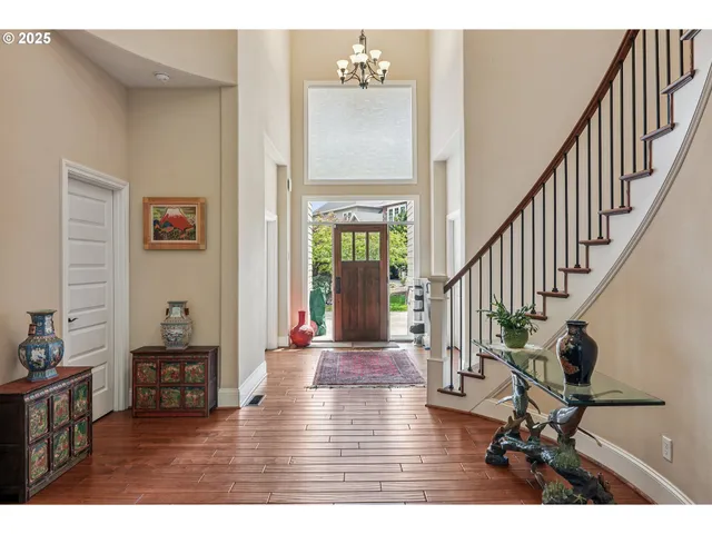 a view of a hallway with wooden floor and furniture