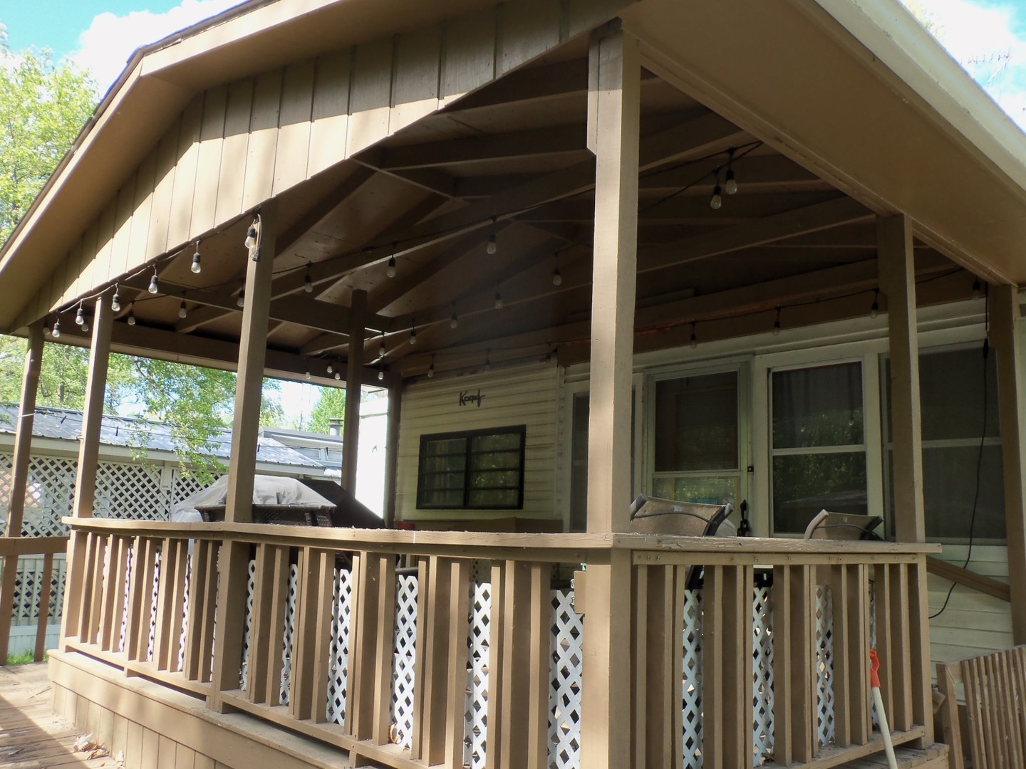 21-216 Woodhaven Sublette, IL 61367 - Photo 4 of 23 a view of small deck with wooden floor and fence
