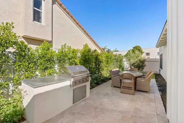 a backyard of a house with outdoor seating