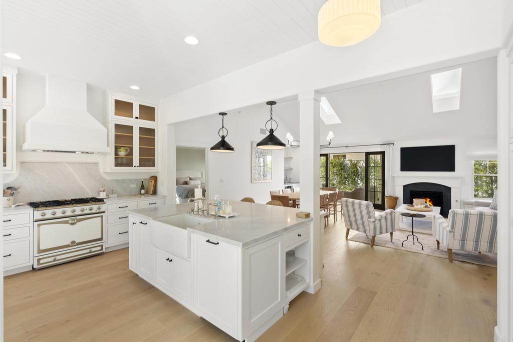 210 Estrella Street Solana Beach, CA 92075 - Photo 3 of 14 a view of living room kitchen with stainless steel appliances granite countertop furniture and a fireplace
