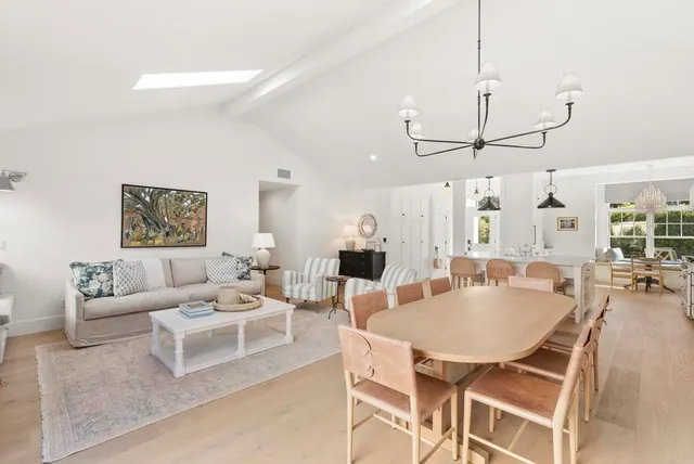 a living room with furniture a rug and white walls