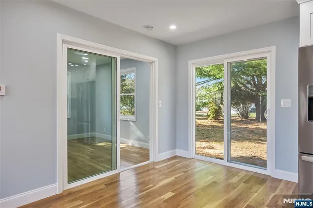 a view of room with window and wooden floor