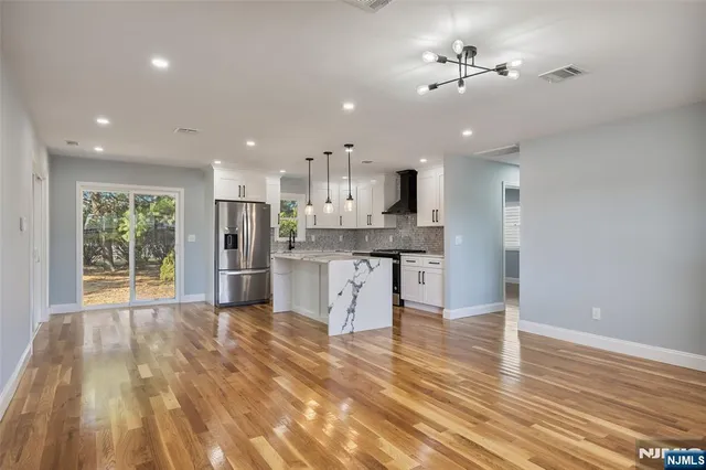 a view of kitchen with granite countertop cabinets and outdoor space
