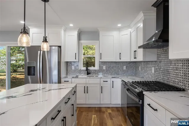 a kitchen with a sink stove and refrigerator