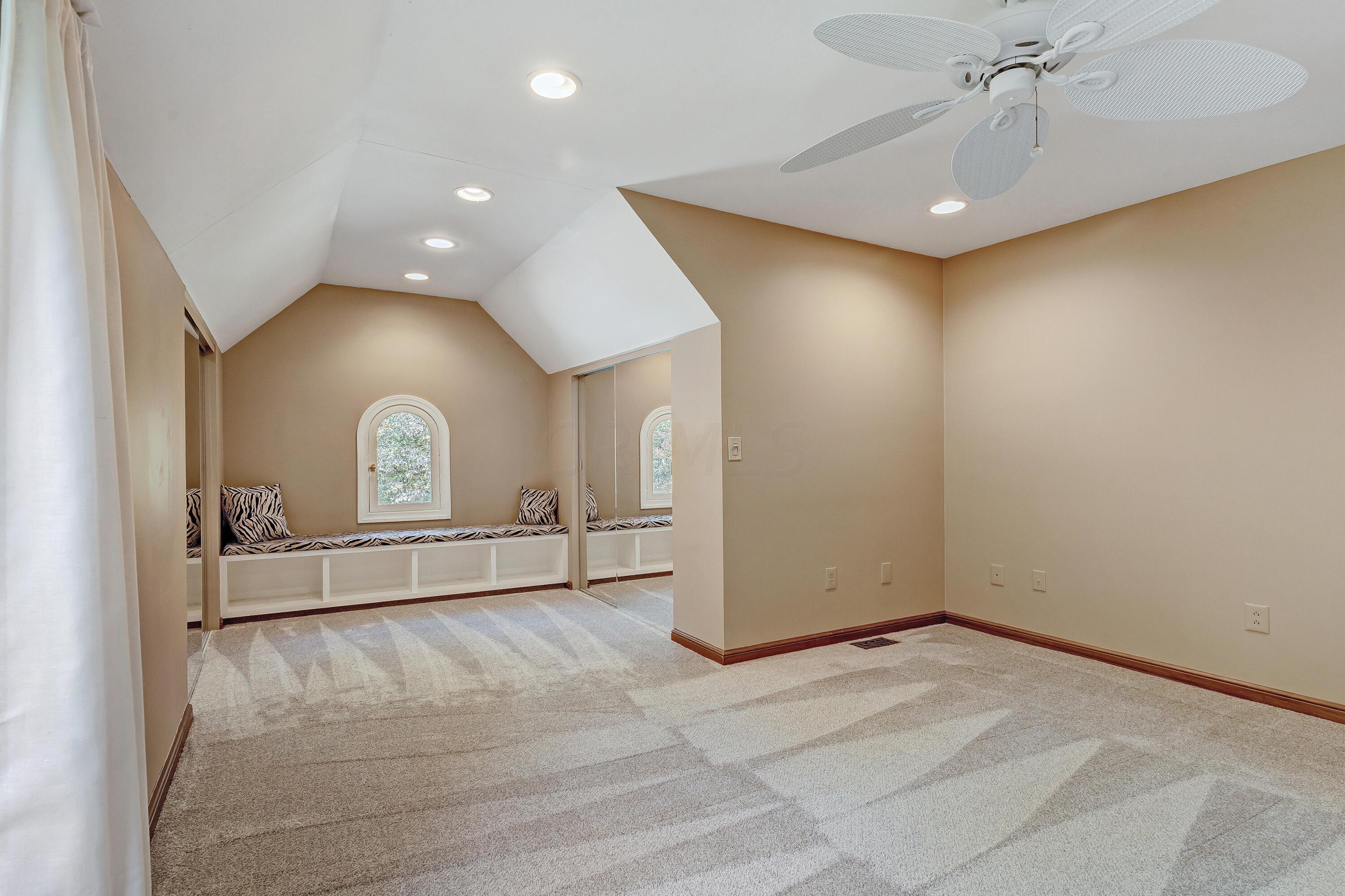 10640 Center Village Road Galena, OH 43021 - Photo 37 of 80 • New light sand carpet ~ 2022 • Tan painted walls • Angled ceiling • Ceiling fan • Can lighting • Bench seat • (2) Closets with double sliding mirrored doors • Jack & Jill Bath access