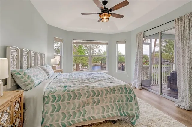 a bedroom with a bed and glass walk in closet