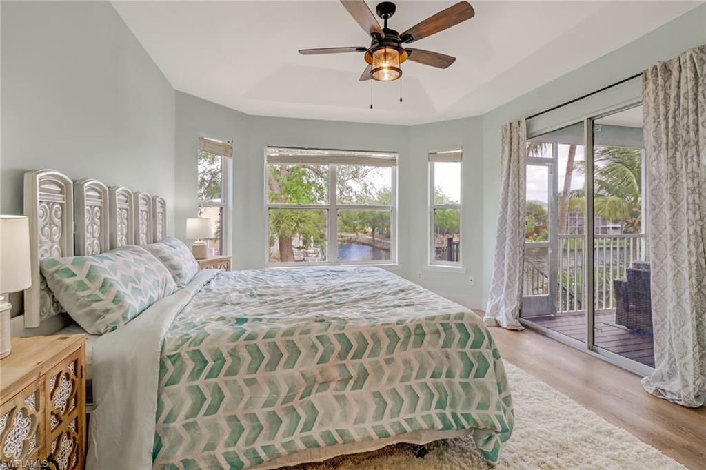 3659 Riviera Circle Bonita Springs, FL 34134 - Photo 23 of 31 a bedroom with a bed and glass walk in closet