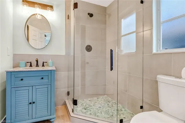 a bathroom with a toilet a sink and a mirror