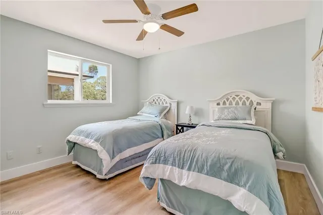 a bedroom with two beds and a chandelier