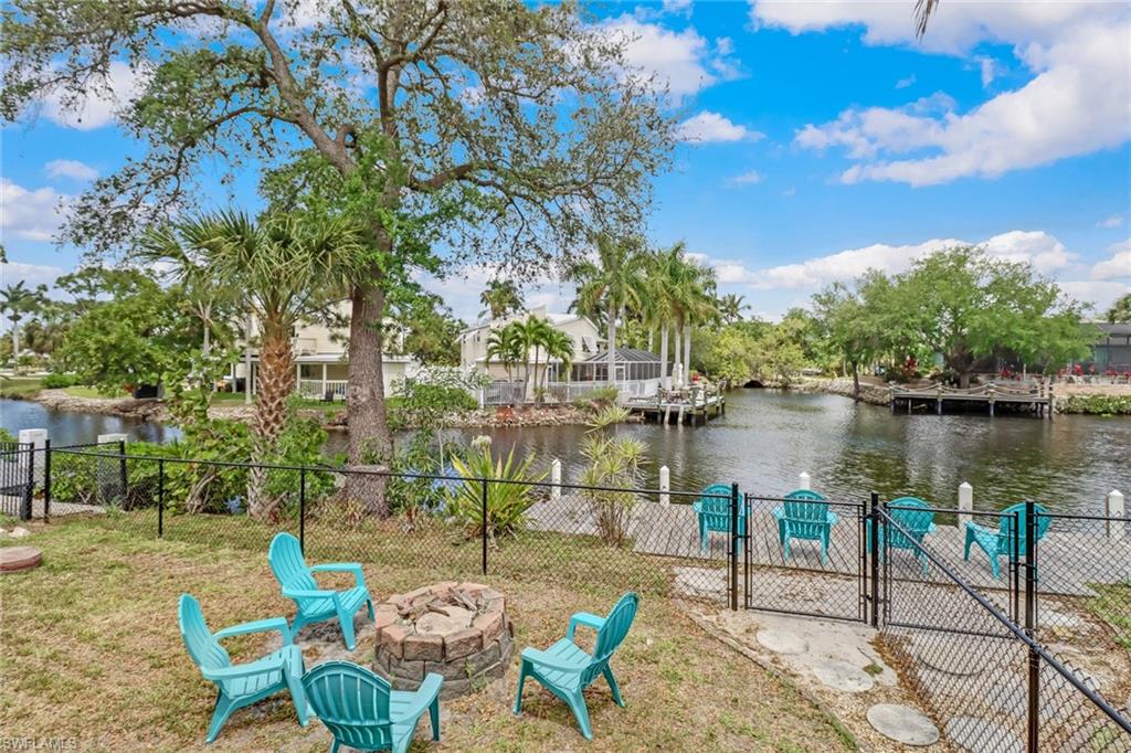 3659 Riviera Circle Bonita Springs, FL 34134 - Photo 30 of 31 a view of a lake with table and chairs and potted plants