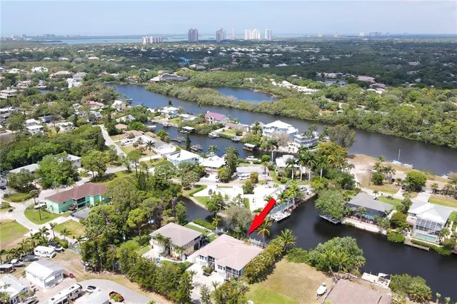 an aerial view of lake and residential houses with outdoor space