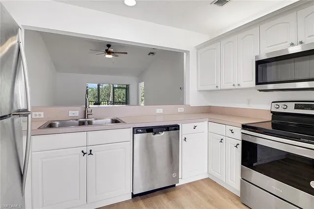 a kitchen with a sink stove and cabinets