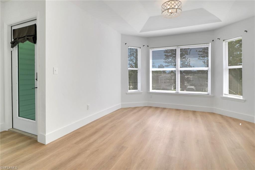 3659 Riviera Circle Bonita Springs, FL 34134 - Photo 6 of 31 a view of an empty room with wooden floor and a window