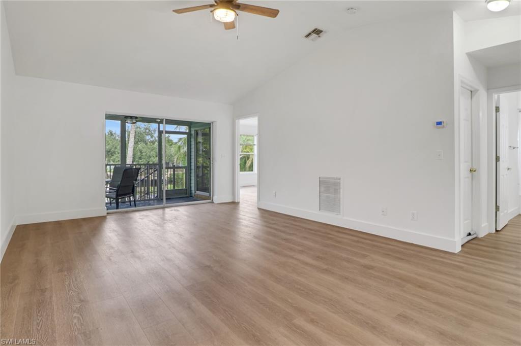 3659 Riviera Circle Bonita Springs, FL 34134 - Photo 9 of 31 an empty room with wooden floor and windows
