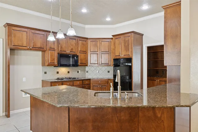 a kitchen with stainless steel appliances granite countertop a sink refrigerator and microwave