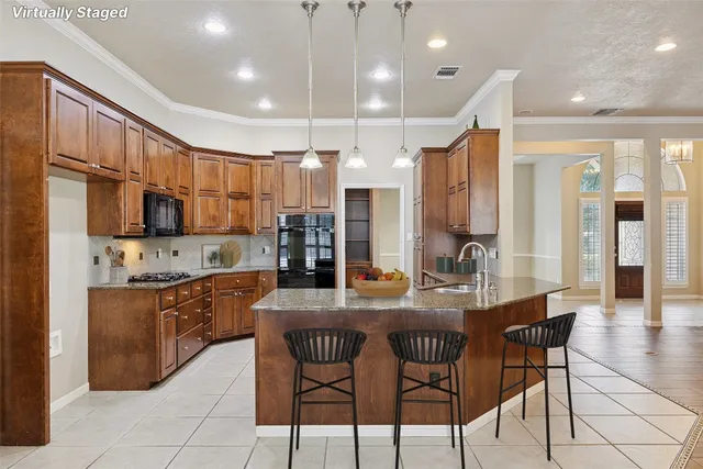 a kitchen with stainless steel appliances kitchen island granite countertop a kitchen island a stove a sink a dining table and chairs