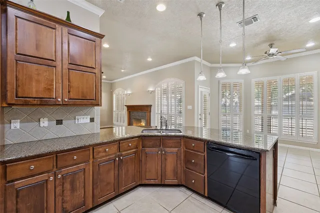 a large kitchen with kitchen island granite countertop a large window and cabinets