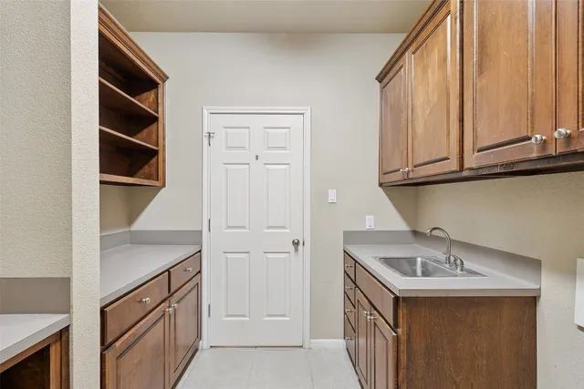 a kitchen with stainless steel appliances granite countertop a sink and dishwasher with white cabinets