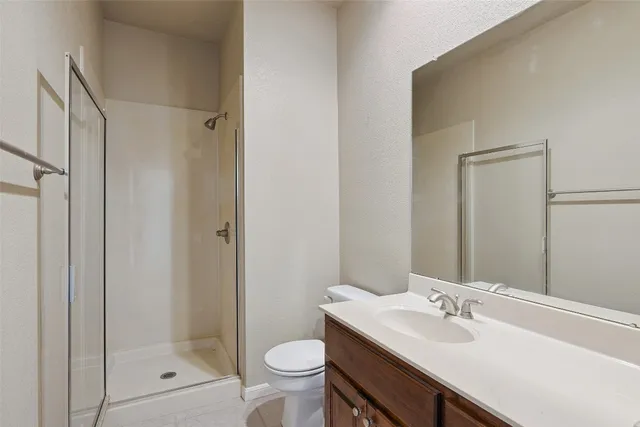 a bathroom with a sink toilet a mirror and shower