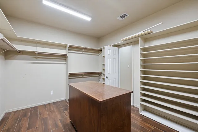 a view of kitchen with stainless steel appliances cabinets and wooden floor