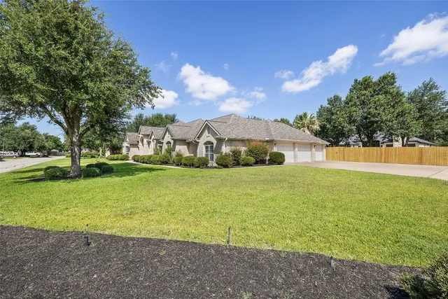 a front view of house with yard and trees