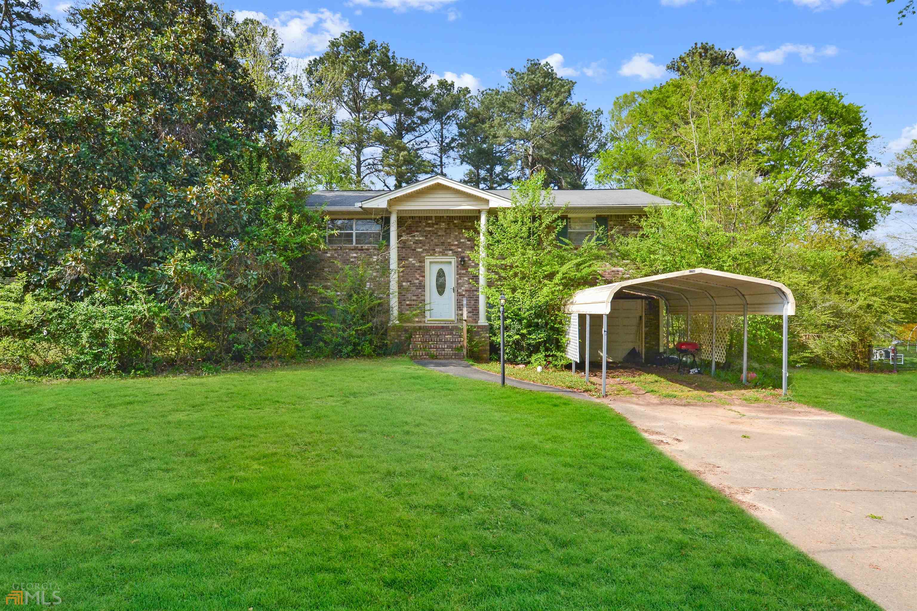 4298 Steading Road Powder Springs, GA 30127 - Photo 1 of 1 a front view of a house with a yard and trees