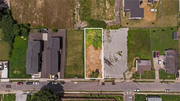 front view of a brick building with a yard