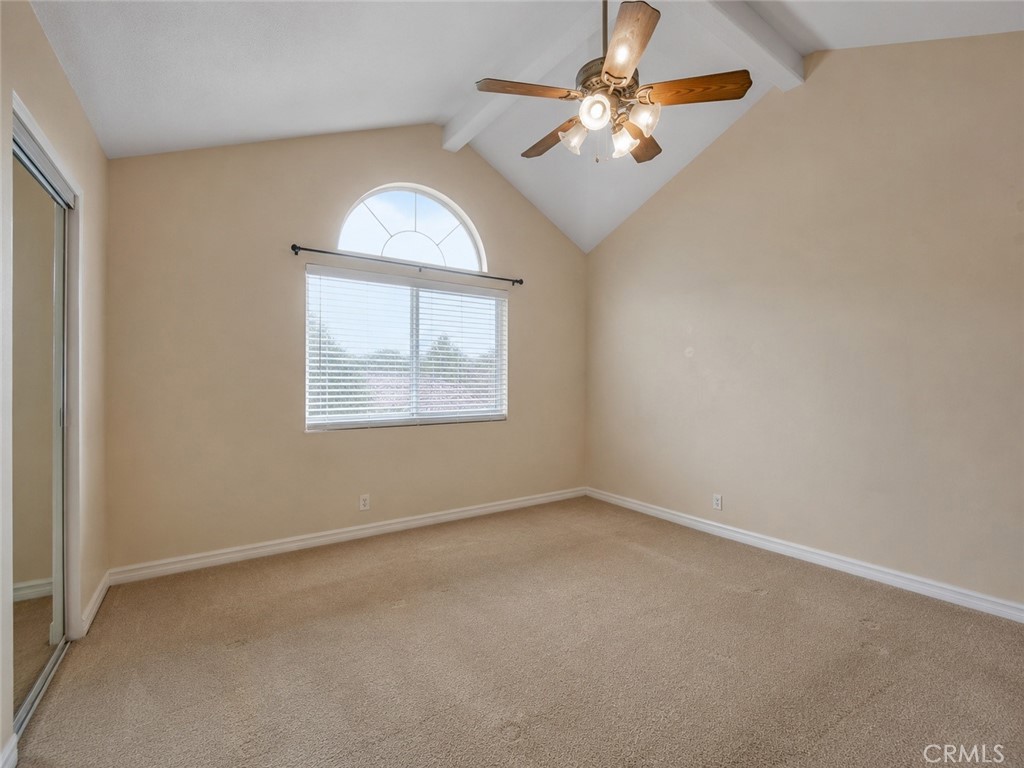 2811 North Roxbury Street Orange, CA 92867 - Photo 5 of 8 an empty room with a chandelier fan and windows
