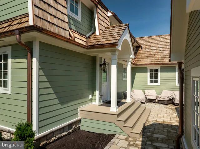 a bathroom with a granite countertop sink and a window