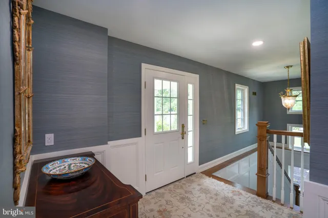 a utility room with wooden floor washer and dryer
