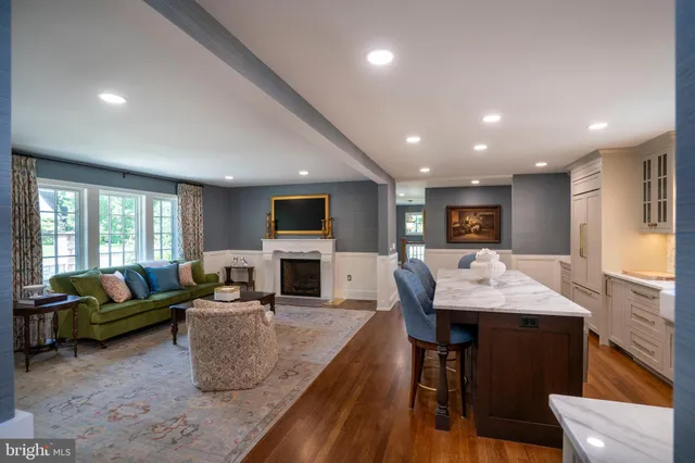 a spacious bedroom with a bed and wooden floor