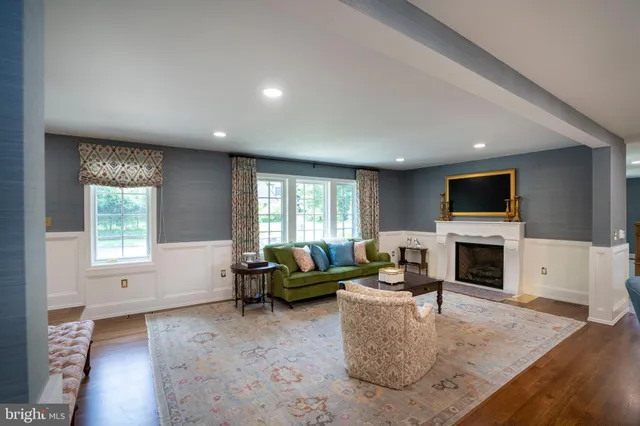 a bathroom with a granite countertop sink toilet a large mirror a vanity and shower